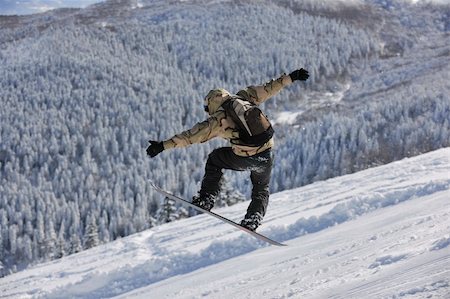 simsearch:400-06133858,k - freestyle snowboarder jump and ride free style  at sunny winter day on mountain Stock Photo - Budget Royalty-Free & Subscription, Code: 400-05204526