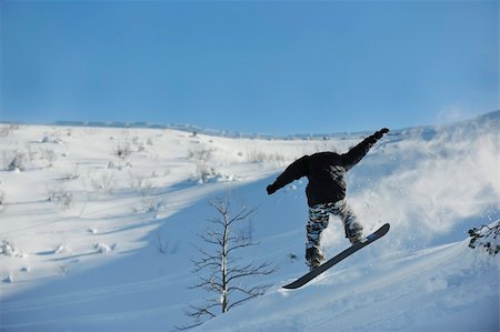 simsearch:400-05204614,k - freestyle snowboarder jump and ride free style  at sunny winter day on mountain Stock Photo - Budget Royalty-Free & Subscription, Code: 400-05204560
