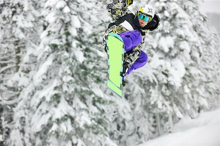 young boys jumping in air ind showing trick with snowboard at winter season Stock Photo - Budget Royalty-Free & Subscription, Code: 400-05204635