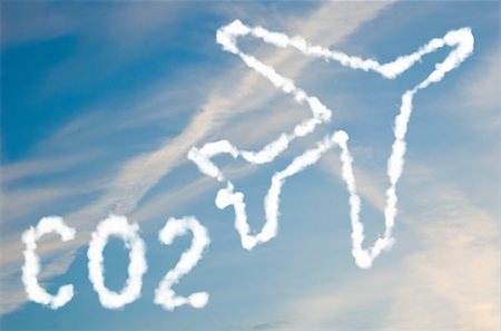 An illustration of an airplane with the text CO2 made up of white puffy clouds to represent environmental issues or carbon footprint. Stock Photo - Budget Royalty-Free & Subscription, Code: 400-05205649