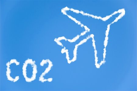An illustration of an airplane with the text CO2 made up of white puffy clouds to represent environmental issues or carbon footprint. Stock Photo - Budget Royalty-Free & Subscription, Code: 400-05205641