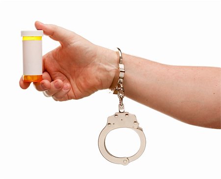 simsearch:400-04616930,k - Handcuffed Man Holding Blank Medicine Bottle Isolated on a White Background. Stockbilder - Microstock & Abonnement, Bildnummer: 400-05205783