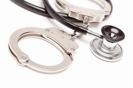 pictures of hands in handcuffs - Stethoscope and Handcuffs Isolated on a White Background. Stock Photo - Budget Royalty-Free & Subscription, Code: 400-05205805