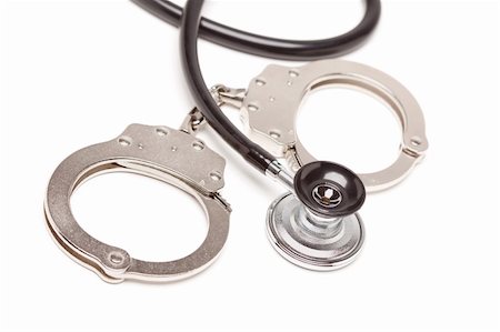 Stethoscope and Handcuffs Isolated on a White Background. Stock Photo - Budget Royalty-Free & Subscription, Code: 400-05205806