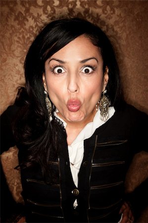 Pretty Hispanic Woman on Gold Background Making a Funny Face Foto de stock - Super Valor sin royalties y Suscripción, Código: 400-05205886