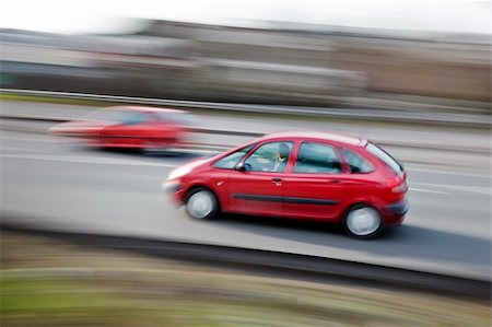 a fast paced car driving along the motorway highway Stockbilder - Microstock & Abonnement, Bildnummer: 400-05208313