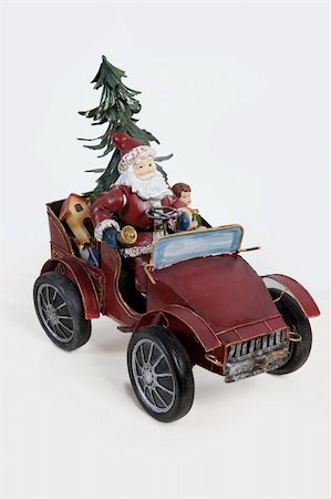 simsearch:400-06639922,k - Statuette of Santa Klaus sitting in an old car on isolated background Stock Photo - Budget Royalty-Free & Subscription, Code: 400-05208373