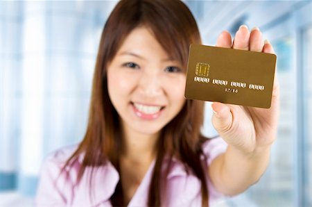 Asian woman holding a credit card, focus on the card. Card number and expiry date created by my own. Stock Photo - Budget Royalty-Free & Subscription, Code: 400-05208735