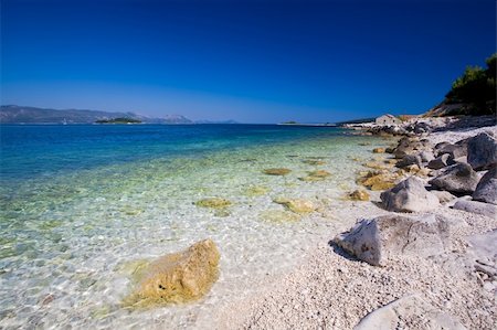 simsearch:400-04831572,k - A beautiful white stone beach with clear blue water off the coast of Korcula. Foto de stock - Super Valor sin royalties y Suscripción, Código: 400-05209607