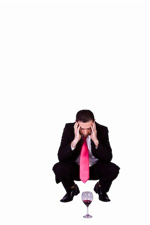 suit squat businessman - Crouched  Stressed Businessman Drinking - Isolated Background Stock Photo - Budget Royalty-Free & Subscription, Code: 400-05200011