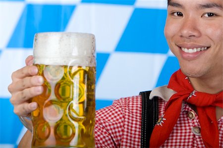 dimple mug - Asian Boy is holding a full Oktoberfest beer stein and smiles happy in camera. Isolated on white. Stock Photo - Budget Royalty-Free & Subscription, Code: 400-05200066