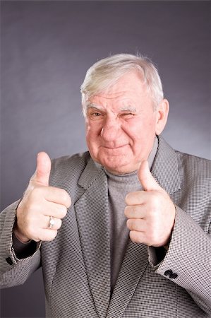 senior man showing thumb up on a grey background Stock Photo - Budget Royalty-Free & Subscription, Code: 400-05200155