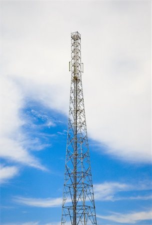 radio tower - Telecommunications mast set against blue sky and big white cloud Stock Photo - Budget Royalty-Free & Subscription, Code: 400-05202234