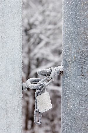 simsearch:400-04359676,k - A padlock is securing a gate with a chain in a snow landscape. Stock Photo - Budget Royalty-Free & Subscription, Code: 400-05202231