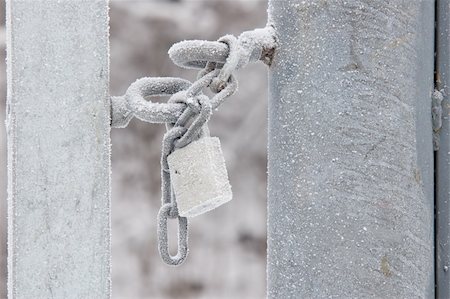 simsearch:400-04359676,k - A padlock is securing a gate with a chain in a snow landscape. Stock Photo - Budget Royalty-Free & Subscription, Code: 400-05202232