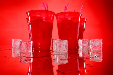 plastic cup for fruit shake - Kid's party vanilla shake in red cups and matching background Stock Photo - Budget Royalty-Free & Subscription, Code: 400-05202469