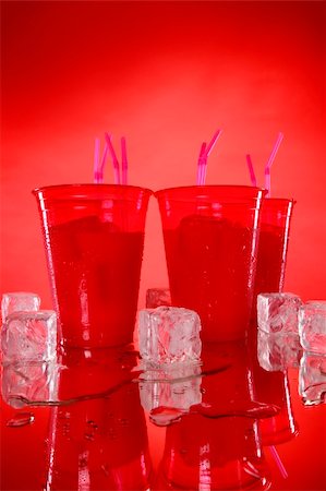 fruit milkshake in plastic cup - Kid's party vanilla shake in red cups and matching background Stock Photo - Budget Royalty-Free & Subscription, Code: 400-05202470