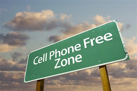 requirement - Cell Phone Free Zone Green Road Sign In Front of Dramatic Clouds and Sky. Stock Photo - Budget Royalty-Free & Subscription, Code: 400-05203502