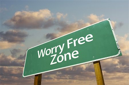 Worry Free Zone Green Road Sign In Front of Dramatic Clouds and Sky. Stock Photo - Budget Royalty-Free & Subscription, Code: 400-05203536
