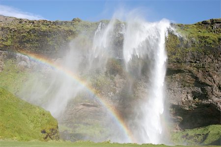 seljalandsfoss waterfall - Seljalandsfoss, one of the many waterfalls on Iceland. Wind pushing back the water! Foto de stock - Royalty-Free Super Valor e Assinatura, Número: 400-05203609