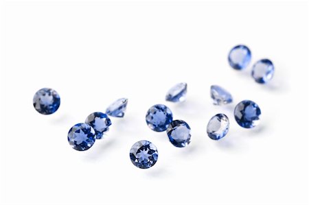 simsearch:400-04728308,k - Group of little faceted sapphires isolated on white. Focus is on the nearest gem. Stock Photo - Budget Royalty-Free & Subscription, Code: 400-05214055