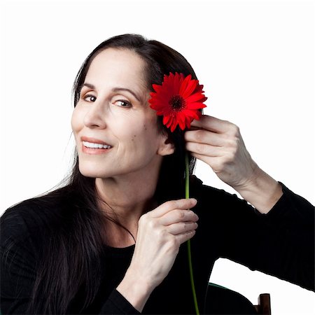 simsearch:400-05213670,k - Woman holding a red daisy, isolated studio image Stock Photo - Budget Royalty-Free & Subscription, Code: 400-05214280