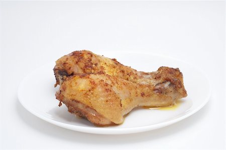 Chicken legs on a plate prepared product. Stockbilder - Microstock & Abonnement, Bildnummer: 400-05214476