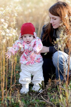 simsearch:400-04825533,k - Young mother with her little baby in a meadow Stock Photo - Budget Royalty-Free & Subscription, Code: 400-05215032