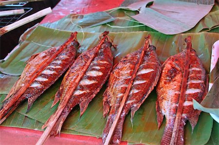 Grilled freshwater fish, lying on banana leaves. Market in Luang Prabang, Laos Stock Photo - Budget Royalty-Free & Subscription, Code: 400-05216007