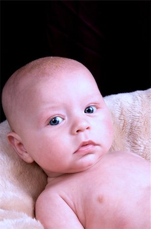 3 month old baby boy with blue eyes lying on a fluffy blanket on a black background Stock Photo - Budget Royalty-Free & Subscription, Code: 400-05216003