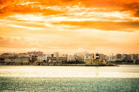 Sunset over Bari city in Italy seen from the harbour. Stock Photo - Budget Royalty-Free & Subscription, Code: 400-05216565