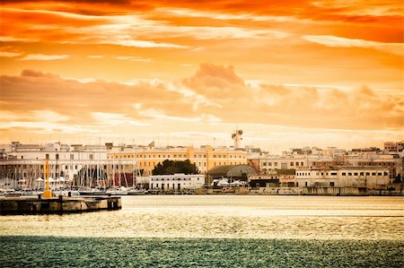 Sunset over Bari city in Italy seen from the harbour. Stock Photo - Budget Royalty-Free & Subscription, Code: 400-05216567