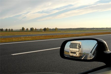 A road in Belorussia with trucks in the rear view mirror Stock Photo - Budget Royalty-Free & Subscription, Code: 400-05217188