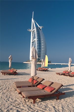 View of the luxury beach of Dubai with the Burj al arab the most exclusive hotel of the world, and one of the few seven star. Here against a strong blue sky. Stockbilder - Microstock & Abonnement, Bildnummer: 400-05218246