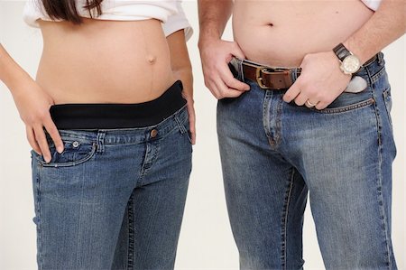 young pregnant couple standing with belly exposed Stockbilder - Microstock & Abonnement, Bildnummer: 400-05218260