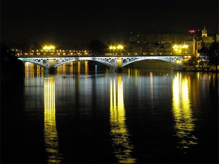 The famous Triana's bridge located in Seville (Spain) that crosses the Guadalquivir river. Foto de stock - Super Valor sin royalties y Suscripción, Código: 400-05218585