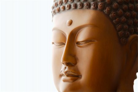 Close up of Buddha head carving against a white background with space for text Stock Photo - Budget Royalty-Free & Subscription, Code: 400-05218606