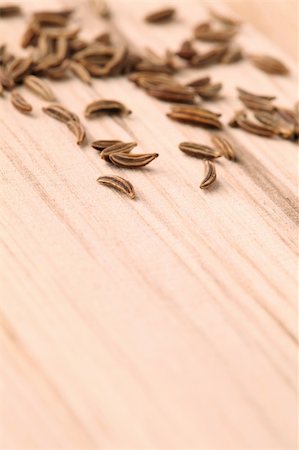 simsearch:400-04754857,k - Closeup of cummin seeds on a wooden table. Shallow dof, selective focus Stock Photo - Budget Royalty-Free & Subscription, Code: 400-05218944