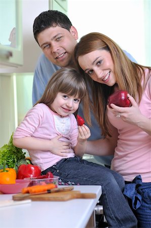 happy young family have lunch time with fresh fruits and vegetable food in bright kitchen Stock Photo - Budget Royalty-Free & Subscription, Code: 400-05210727