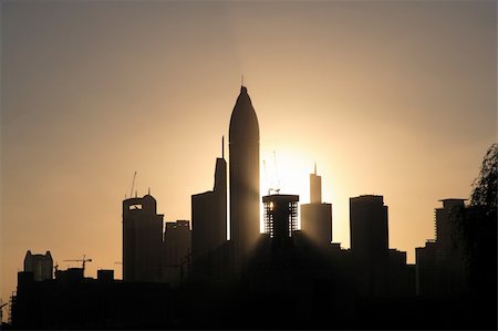 Sunset over Dubai with many towers in front. Fotografie stock - Microstock e Abbonamento, Codice: 400-05211183