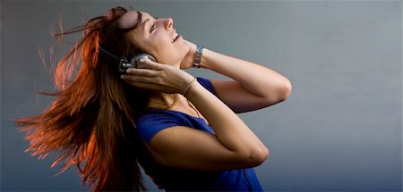 Young girl having fun at a disco or nightclub with retro headphones listening to music Stock Photo - Budget Royalty-Free & Subscription, Code: 400-05211635