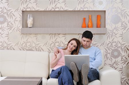 young couple at home with  modern livingroom indoor working on laptop on house finance and planing Stock Photo - Budget Royalty-Free & Subscription, Code: 400-05211736