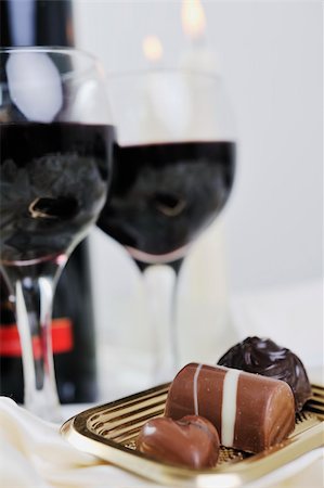 fire romance - luxury and sweet praline and chocolate with wine bottle and glasses  decoration Stock Photo - Budget Royalty-Free & Subscription, Code: 400-05211823