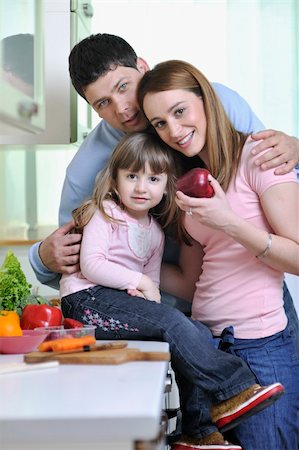happy young family have lunch time with fresh fruits and vegetable food in bright kitchen Stock Photo - Budget Royalty-Free & Subscription, Code: 400-05211854