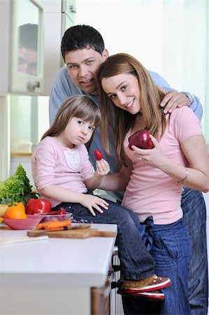 happy young family have lunch time with fresh fruits and vegetable food in bright kitchen Stock Photo - Budget Royalty-Free & Subscription, Code: 400-05211855