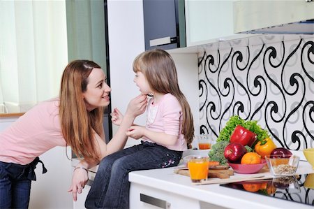 happy young family have lunch time with fresh fruits and vegetable food in bright kitchen Stock Photo - Budget Royalty-Free & Subscription, Code: 400-05211858