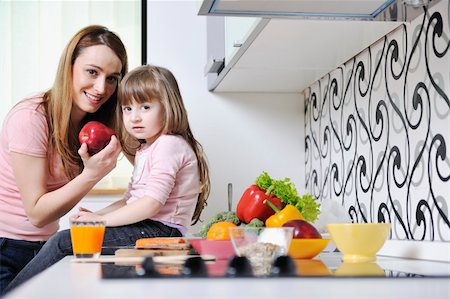 happy young family have lunch time with fresh fruits and vegetable food in bright kitchen Stock Photo - Budget Royalty-Free & Subscription, Code: 400-05211859