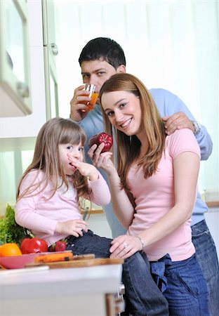 happy young family have lunch time with fresh fruits and vegetable food in bright kitchen Stock Photo - Budget Royalty-Free & Subscription, Code: 400-05211852