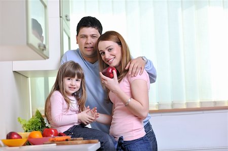 happy young family have lunch time with fresh fruits and vegetable food in bright kitchen Stock Photo - Budget Royalty-Free & Subscription, Code: 400-05211853