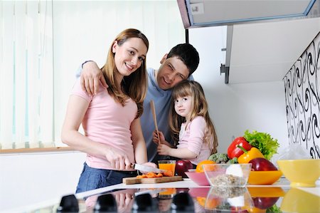 happy young family have lunch time with fresh fruits and vegetable food in bright kitchen Stock Photo - Budget Royalty-Free & Subscription, Code: 400-05211864